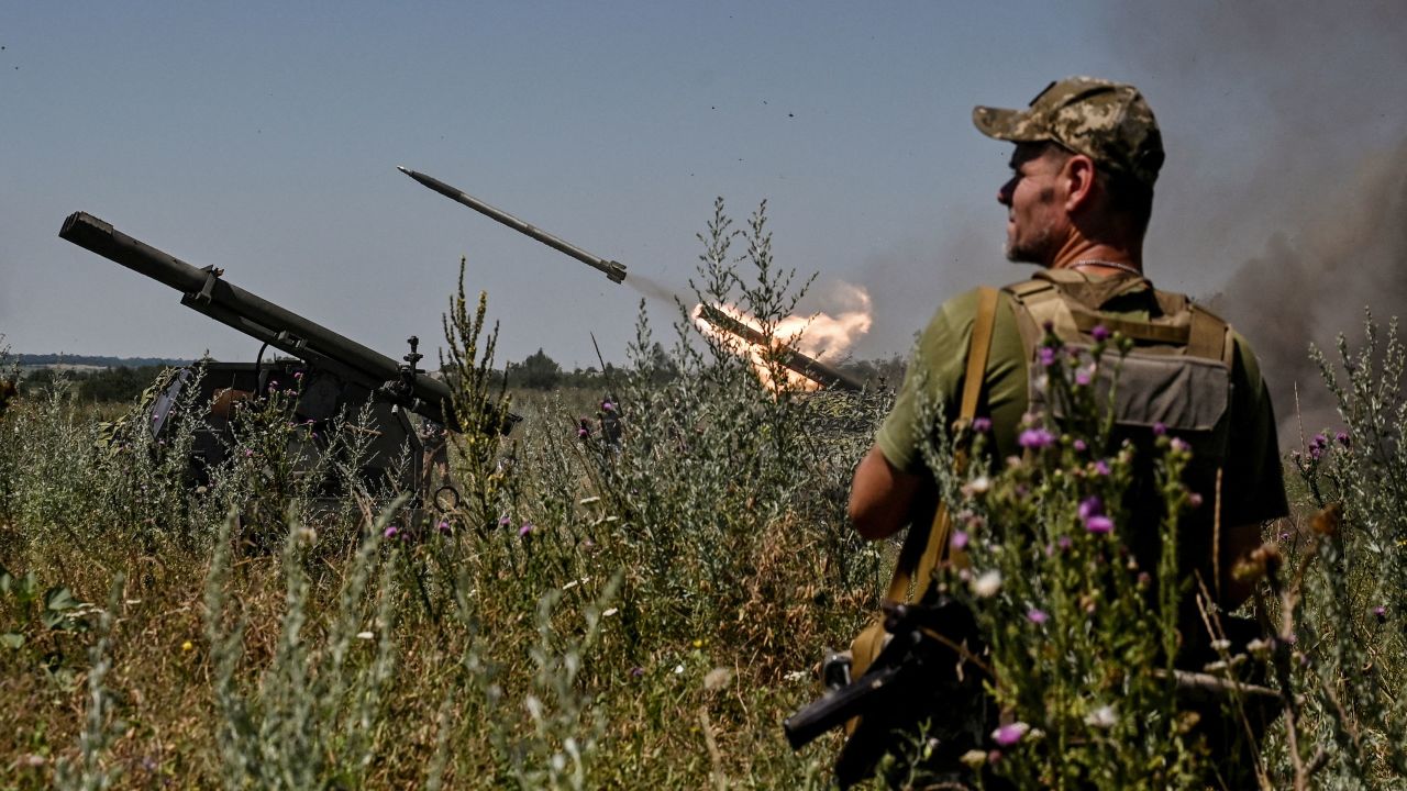 Ukrainian servicemen fire a Partyzan small multiple rocket launch system toward Russian troops near a front line.