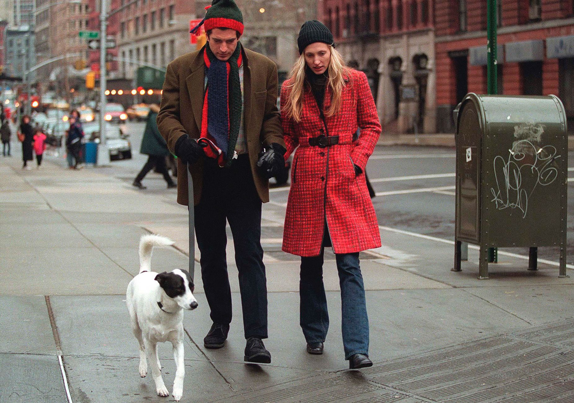 Carolyn Bessette Kennedy and her husband John F. Kennedy Jr walk their dog in Manhattan.